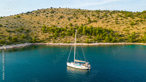 An aerial view of a serene bay on Otok Žut, located near the Kornati Islands in Croatia. The bay, surrounded by lush greenery and rocky shores, offers a tranquil retreat in the Adriatic Sea photo