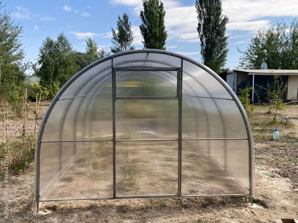 Installation of a metal frame greenhouse with polycarbonate covering Installation of a metal frame greenhouse with polycarbonate covering
