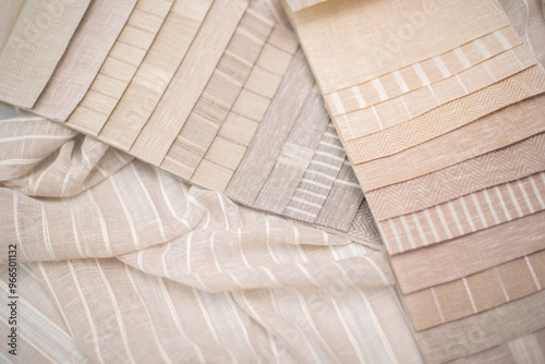 A palette of linen fabric with different stripes in beige tones. Fabric for curtains and tulles. photo