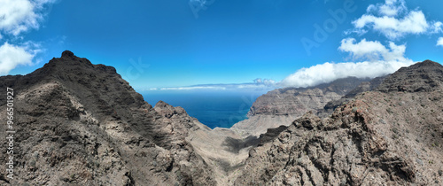 Aerial view of the trail through the mountains to Guigui beach, pristine black sand beach, Gran Canaria. Spain. Scenic trail
 photo