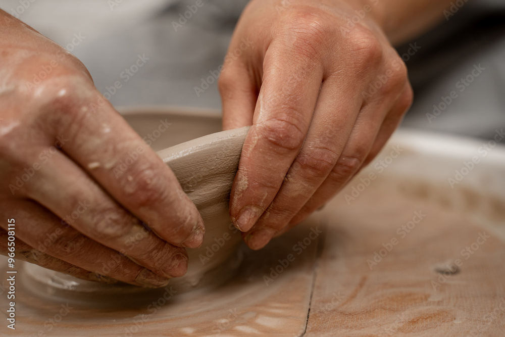 Creating a ceramic bowl by yourself in a pottery class. Wheel throwing. Learning how to model clay into different shapes with pottery wheel. Creating a ceramic bowl by yourself in a pottery class. Wheel throwing. Learning how to model clay into different shapes with pottery wheel.