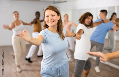 Adult man and adult woman dancing pair dance in dance hall photo