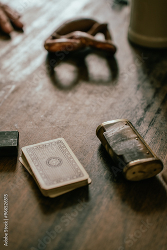 Antique cigarette case, deck of cards and pretzel in an old German restaurant photo