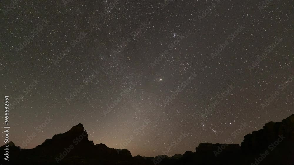 Stars wheel across the sky and satellites streak through the view above the Grapevine trail in Zion Nat. Park, Utah, USA as the night gives way to warm pink which turns to the blue of pre dawn light. Stars wheel across the sky and satellites streak through the view above the Grapevine trail in Zion Nat. Park, Utah, USA as the night gives way to warm pink which turns to the blue of pre dawn light.