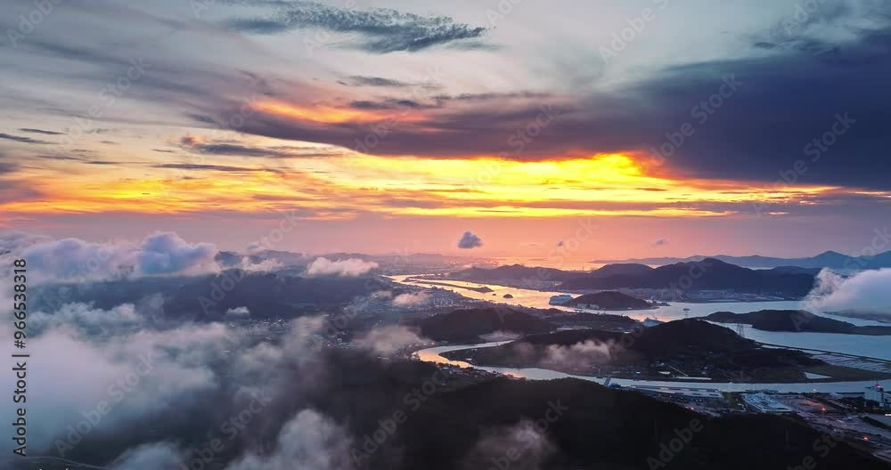 Aerial shot of curving river and mountains with cloudscape at sunset Aerial shot of curving river and mountains with cloudscape at sunset
