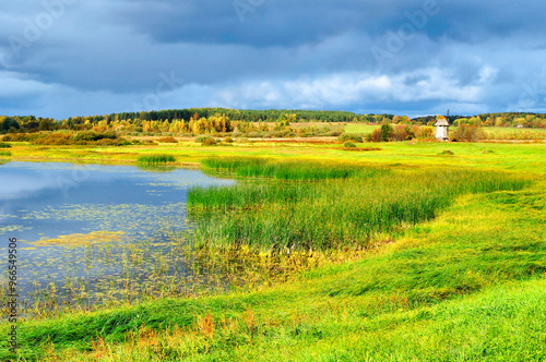 Autumn landscape - picturesque rural autumn landscape of the river valley and windmill in sunny weather, rural autumn view