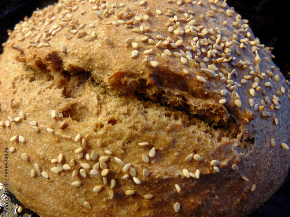 Fototapeta premium loaf of whole wheat bread with seeds on top