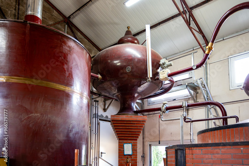 Double distillation process of cognac spirit in Charentias copper alambic still pots and boilers in old distillery in Cognac white wine region, Charente, Segonzac, Grand Champagne, France photo