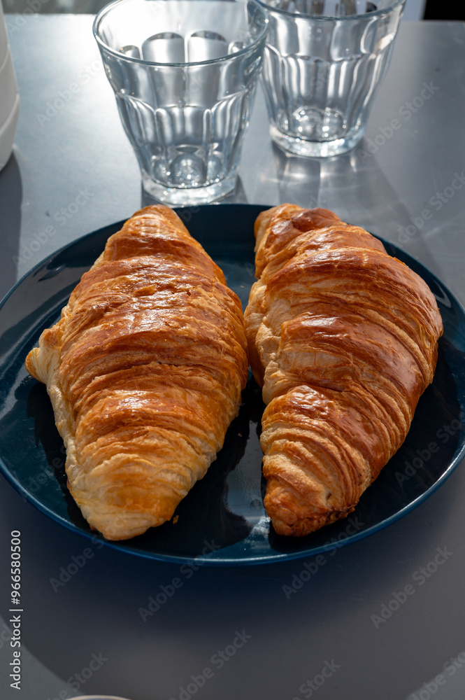 Fresh baked buttered croissants served in restaurant for continental or French breakfast close up