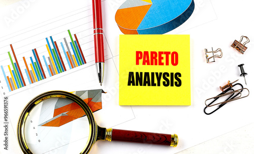 Pareto analysis concept with charts, magnifying glass, sticky note, and office supplies