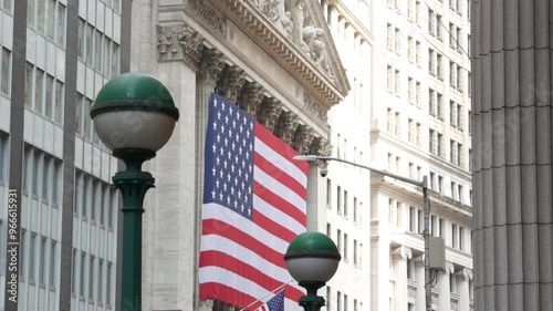 New York City, United States. Manhattan Downtown Financial District urban architecture. Huge big American flag. Wall street Stock Exchange building, USA Stock Market. Subway entrance, metro orb globe.