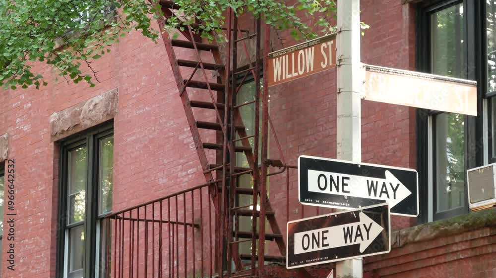 New York City crossroad, Brooklyn Heights Willow street intersection, one way road sign. Residential district architecture, red brick house, United States. Fire ladder and corner text roadsign. New York City crossroad, Brooklyn Heights Willow street intersection, one way road sign. Residential district architecture, red brick house, United States. Fire ladder and corner text roadsign.