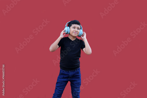 9-year-old brown Latino boy with sound-isolating headphones for autism spectrum disorder, ADHD and sensitivity to loud noises photo