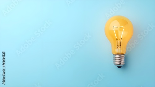 A bright yellow light bulb on a light blue background, symbolizing ideas, innovation, and creativity.