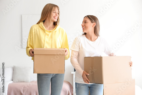 Female students with boxes ...