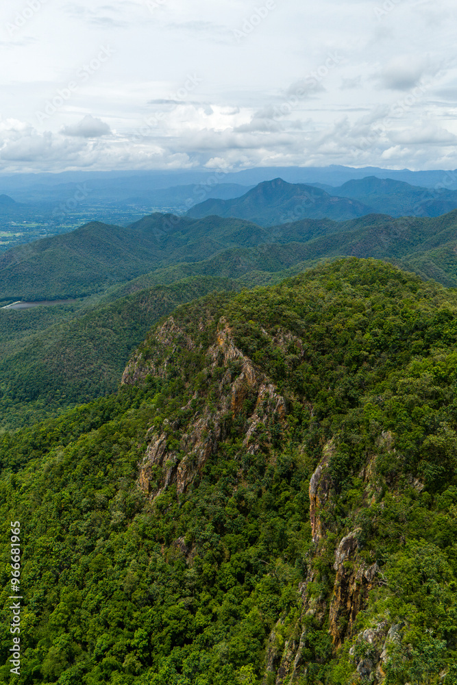 Stunning aerial view of dense green mountains and valleys with a cloudy sky in the background, showcasing natural beauty and tranquility. Stunning aerial view of dense green mountains and valleys with a cloudy sky in the background, showcasing natural beauty and tranquility.