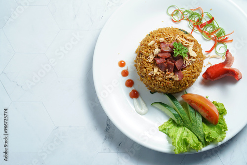 A Plate of Nasi Goreng With Rice, Vegetables, and Sausage on Marble Table