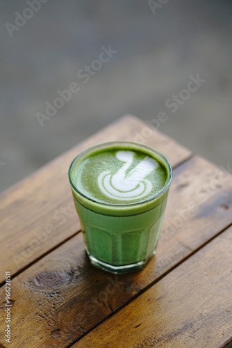 Cup of Matcha Latte With Latte Art on White Marble Table