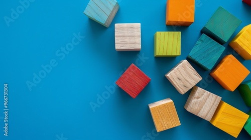 Wooden multicolor cubes for children on a blue background