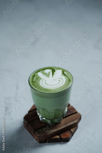 Cup of Matcha Latte With Latte Art on White Marble Table