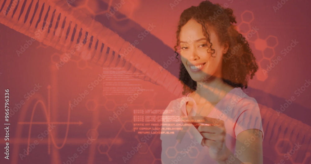 Image of dna strand and data processing over african american woman holding pink ribbon Image of dna strand and data processing over african american woman holding pink ribbon