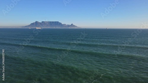 Drone dolly over Table Bay towards landmark Table Mountain in Cape Town RSA photo