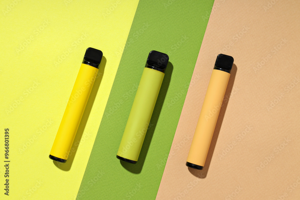 Three electronic cigarettes on a light background Three electronic cigarettes on a light background
