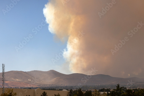 Galena G on the side of a hill in Reno with a huge orange column of smoke rising behind it