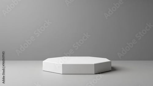 A white, 3D hexagonal platform stands out against a gray background. This mockup shows a hexagonal podium, perfect for displaying products or creating museum displays.