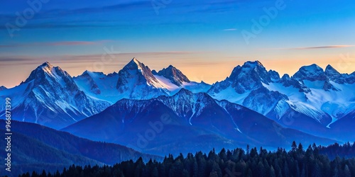Serene mountain range with snow capped peaks silhouette during blue hour