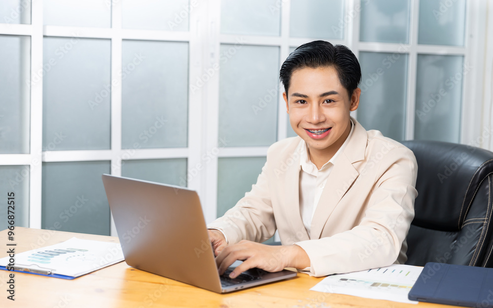 Asian businessman working in his office reviewing work, accessing planning strategy, creative thinking and innovation ideas, happy smiling sitting at desk on laptop computer professional worker. Asian businessman working in his office reviewing work, accessing planning strategy, creative thinking and innovation ideas, happy smiling sitting at desk on laptop computer professional worker.