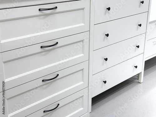 White wooden cabinets with black handles are used to decorate rooms.