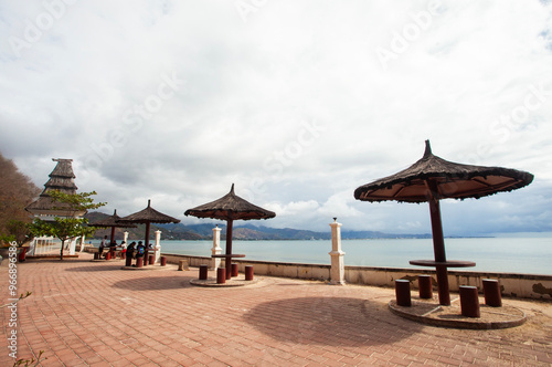 Gazebo with with traditional roof on the edge of Cristho Rei Beach in Dili, East Timor. Cristo Rei Beach is a beautiful beach tourist attraction in Dili and also home to the Christ the King Statue.