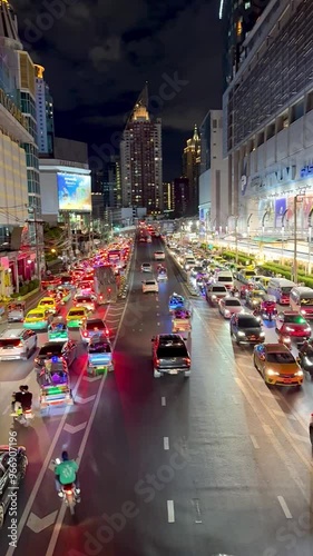 4K Video footage. View of Bangkok busy shopping district of Pratunam and Platinum Fashion Mall, with dense traffic jam along the big road during peak hours in the evening. photo