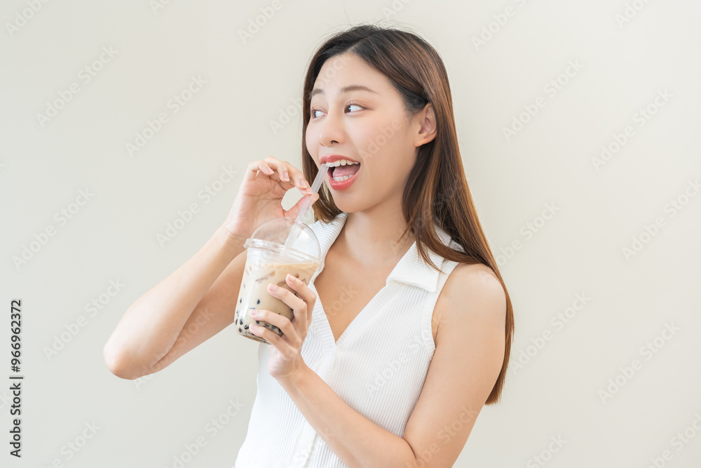 Beverage and food concept, Happy asian young woman hand holding plastic cup, glass of drink bubble, pearl milk tea with straw, cute girl drinking ice cold tea with tapioca boba ball popular in Taiwan. Beverage and food concept, Happy asian young woman hand holding plastic cup, glass of drink bubble, pearl milk tea with straw, cute girl drinking ice cold tea with tapioca boba ball popular in Taiwan.
