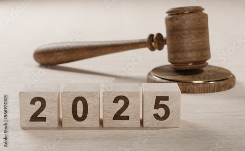 2025 New Year and judge gavel on table. Justice, Law, lawyer, judgment, justice, new laws, rules, decrees, taxes, precedents, court decisions, auction. new laws in year 2025. photo