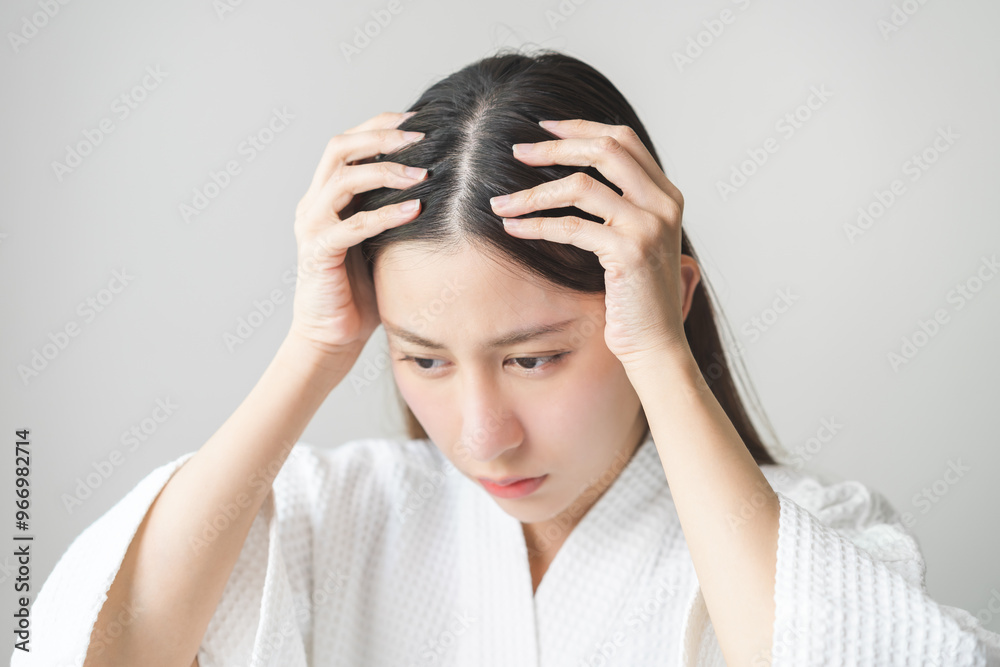 Damaged Hair symptom, face serious asian young woman, girl worry about balding, looking at scalp in mirror, hand in break into front hair loss, thin problem. Health care treatment for beauty concept. Damaged Hair symptom, face serious asian young woman, girl worry about balding, looking at scalp in mirror, hand in break into front hair loss, thin problem. Health care treatment for beauty concept.