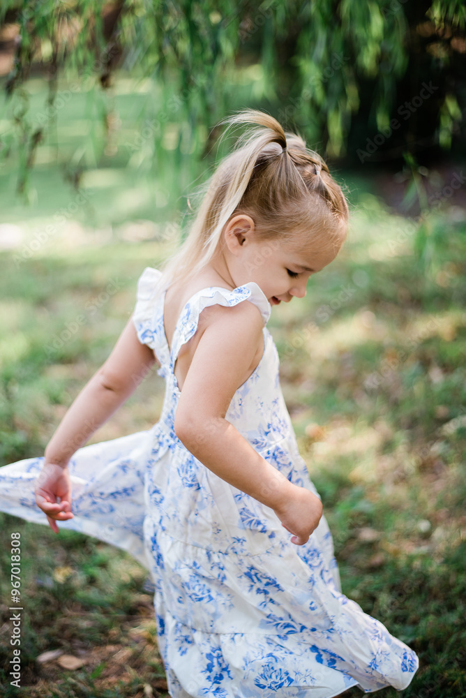 Playful Twirls: Little Girl Enjoying a Sunny Day Playful Twirls: Little Girl Enjoying a Sunny Day
