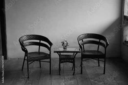 Minimalist Wicker Chairs with Table and Flower Arrangement.