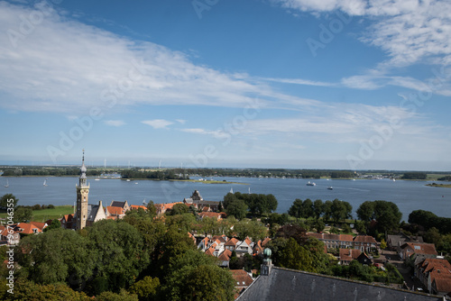 elevated view of Veere Zeeland. Town Hall stadhuis in Dutch shot from  impressive gothic grote kerk church building landmark. skyline before veerse meer in popular historic destination  photo