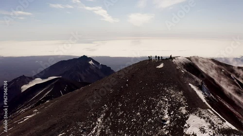 A group of people on top of the Avachinsky volcano
