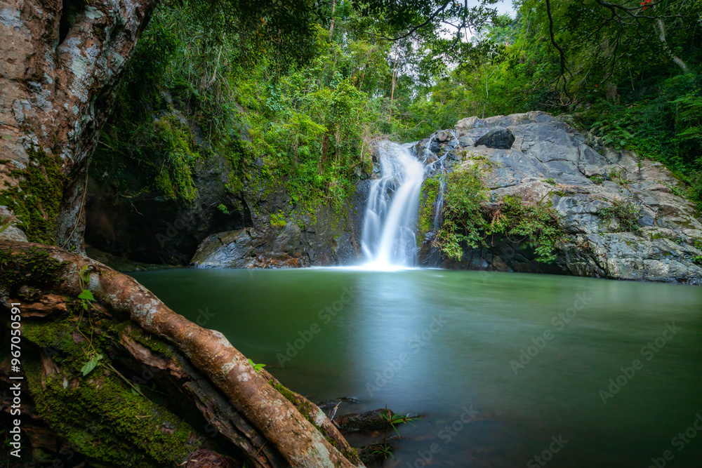 Fototapeta premium Jed Kot Waterfall. Jedkod-Pongkonsao Hiking and Camping Park ,Saraburi. The image could be named Waterfall Amidst the Lush Jungle Forest