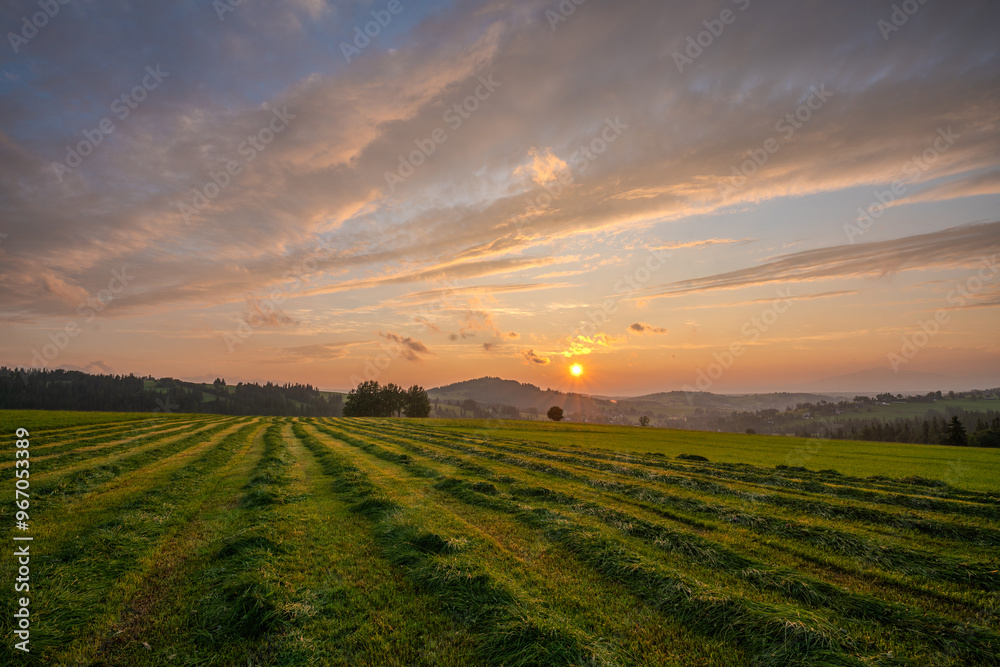 Sunset over a mountain meadow during the haying season Sunset over a mountain meadow during the haying season
