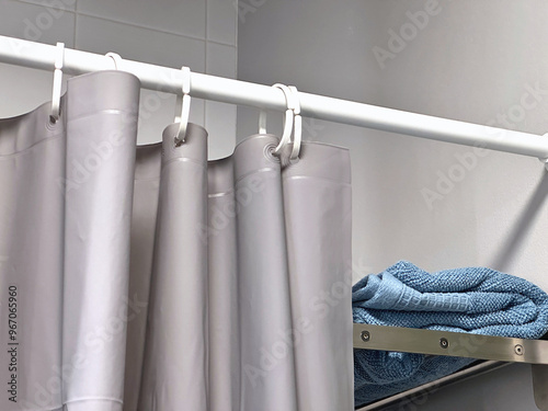 Curtains with waterproof plastic rails divide the shower area. photo