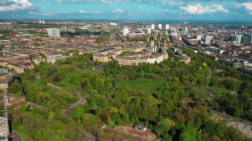 Aerial footage over Kelvingrove Park, cityscape of Glasgow. Flying towards the elegant buildings of Park Circus Place photo