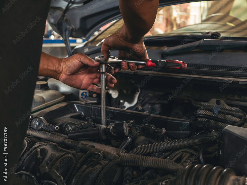 Close up Car Mechanic man hands repairing car auto repair shop. Man hands fixing machinery vehicle mechanical service. open vehicle hood checking up auto mobile. Vehicle Car maintenance engineer. Close up Car Mechanic man hands repairing car auto repair shop. Man hands fixing machinery vehicle mechanical service. open vehicle hood checking up auto mobile. Vehicle Car maintenance engineer.