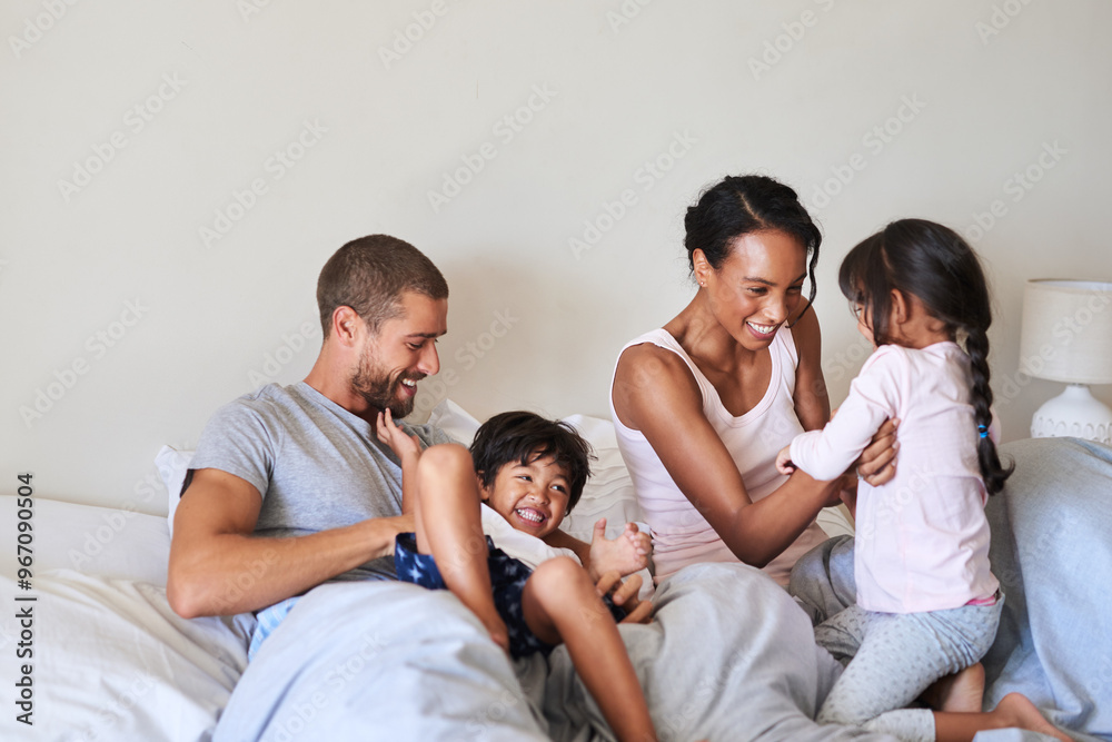 Mom, dad and children in bedroom for playing, bonding and happy relationship in morning. Family, childhood and mother, father and kids tickle for laughing, fun and relax on bed together in home Mom, dad and children in bedroom for playing, bonding and happy relationship in morning. Family, childhood and mother, father and kids tickle for laughing, fun and relax on bed together in home