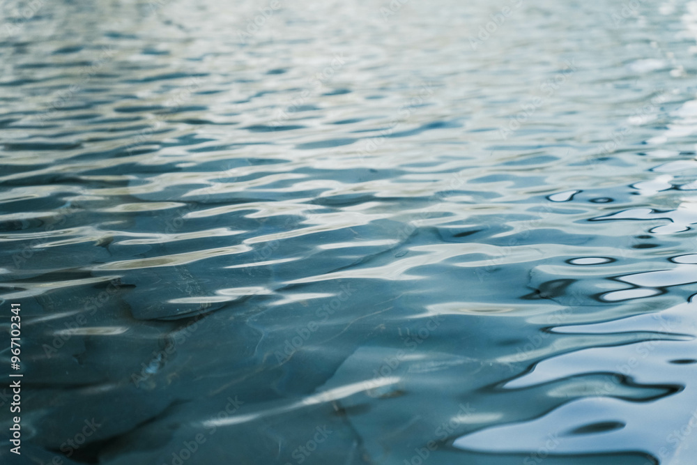 The texture of ripples on the water in a pond. Abstract natural background.