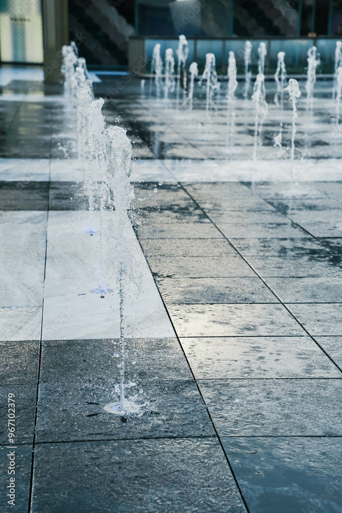 A tall fountain that shoots down from the ground