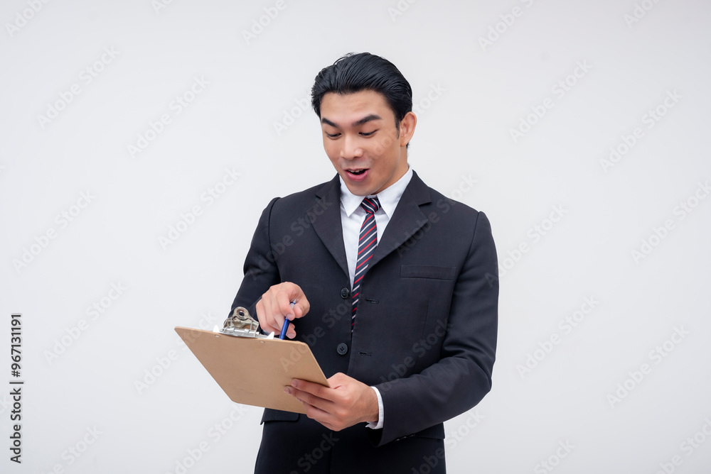 A young asian business executive holding a clipboard, looking amazed and elated on good sales figures. Isolated on a white background. A young asian business executive holding a clipboard, looking amazed and elated on good sales figures. Isolated on a white background.